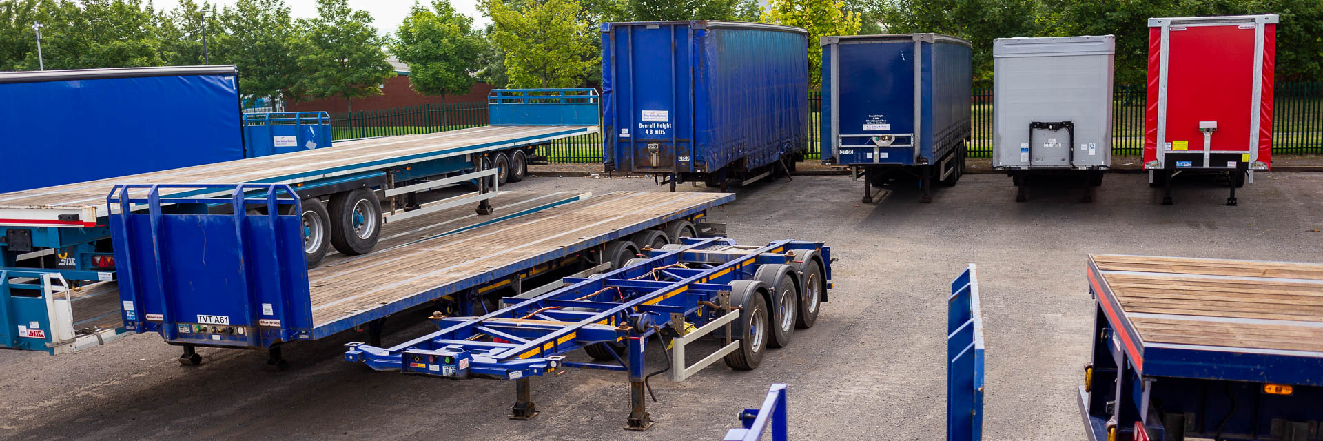 Photo of various types of fully serviced commercial trailers for hire by Tees Valley Trailers. Skeletal, Curtain Sider and Flat trailers are all shown.